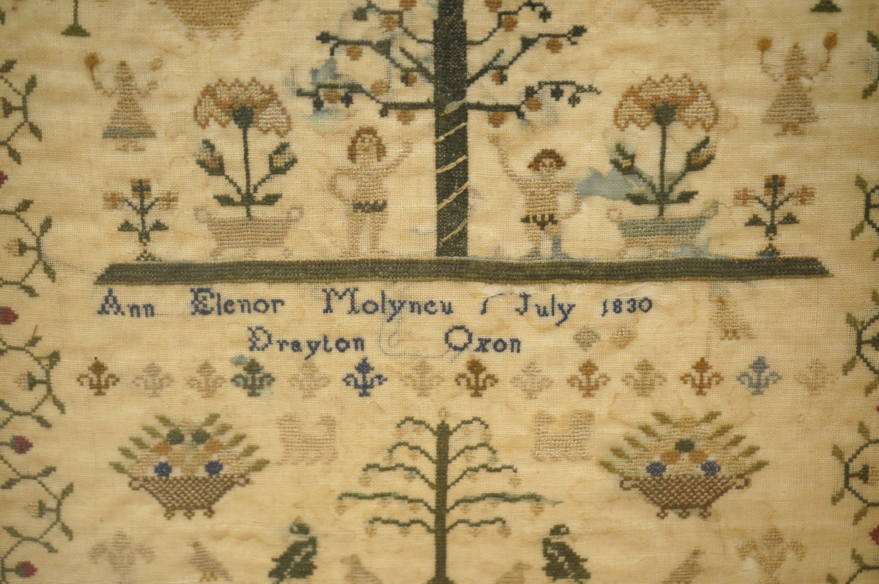 A framed Adam and Eve finely embroidered sampler, by Ann Elenor Molyneu, dated July 1830, Drayton, Oxon, embroidered on fine linen with multi-coloured silks and geometric stylistic floral border, with a short verse above